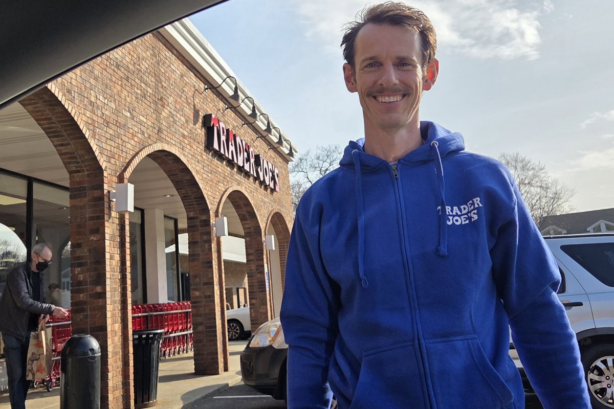 Terence Carr outside a Trader Joe's store, wearing the company hoodie.